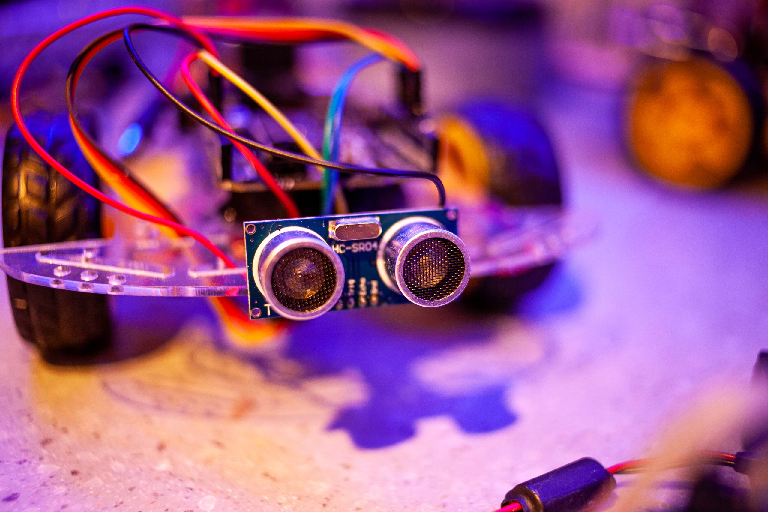 Detailed view of a robotic vehicle component showcasing wires and sensors.